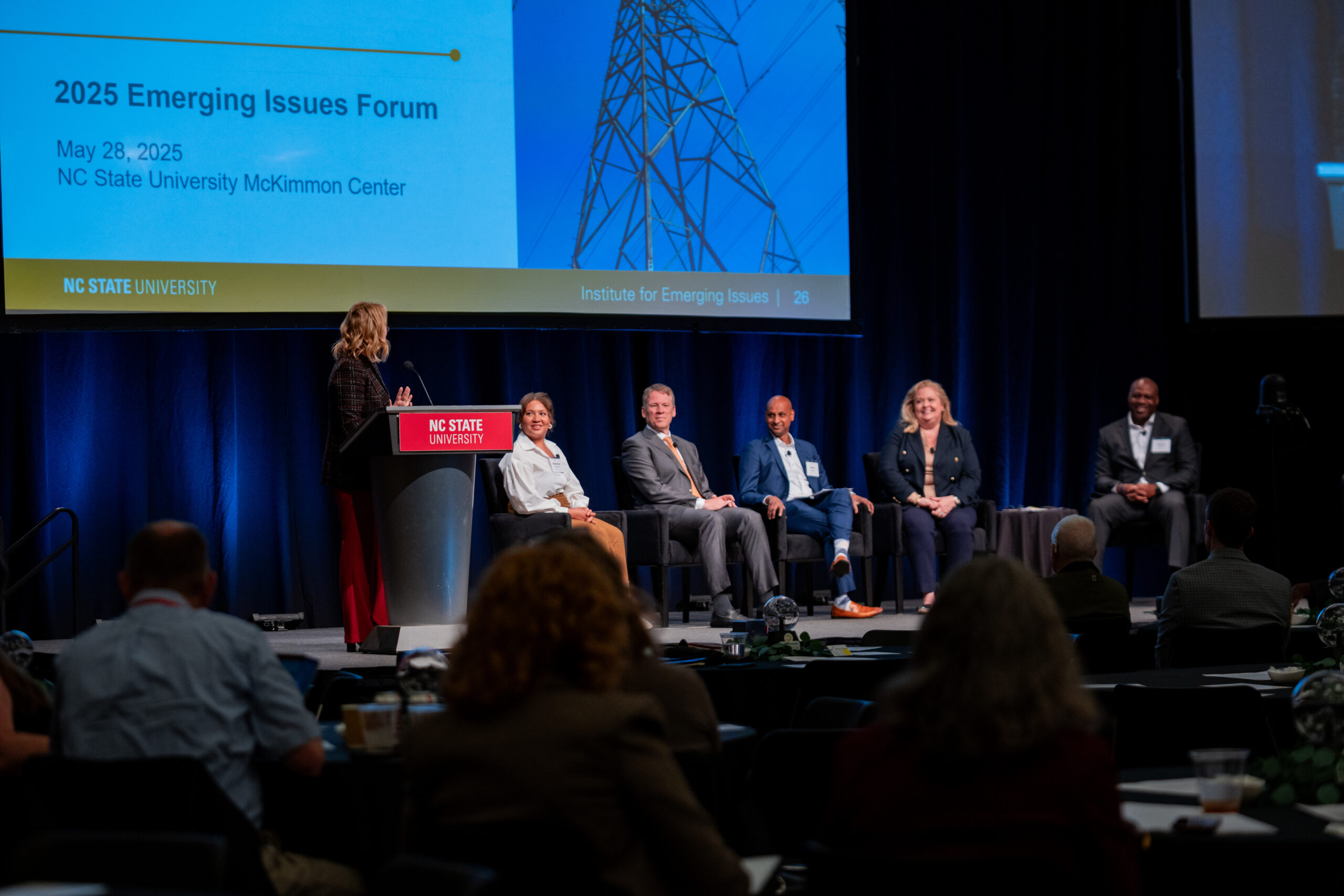 Photo of speakers on stage at the 2025 Emerging Issues Forum.